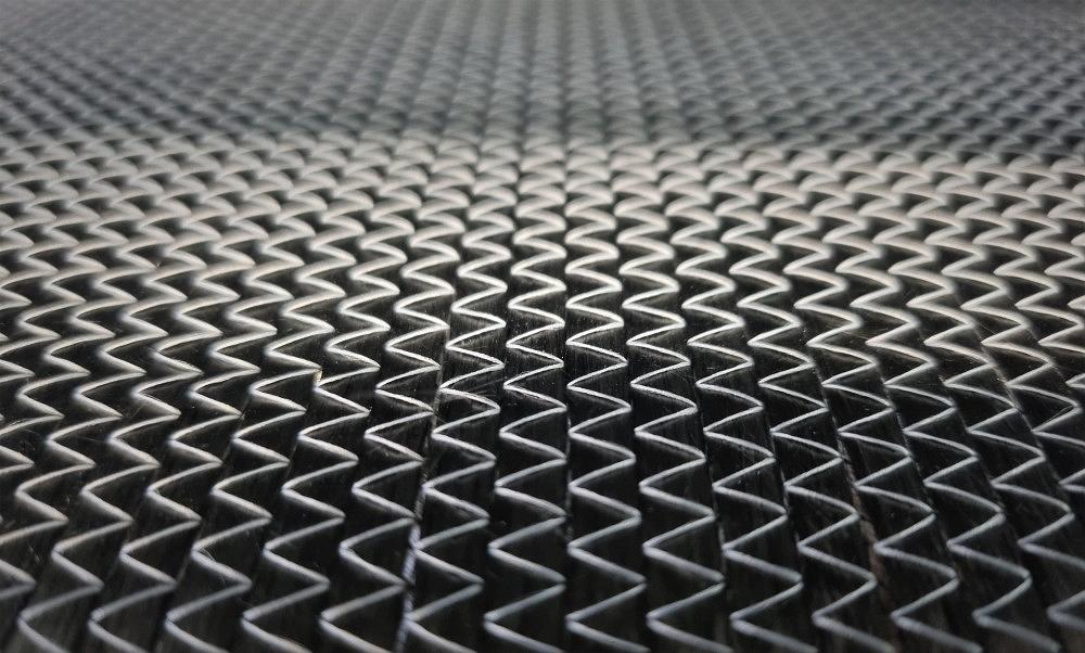 Macro shot of a CFRP surface showing the characteristic carbon fiber pattern